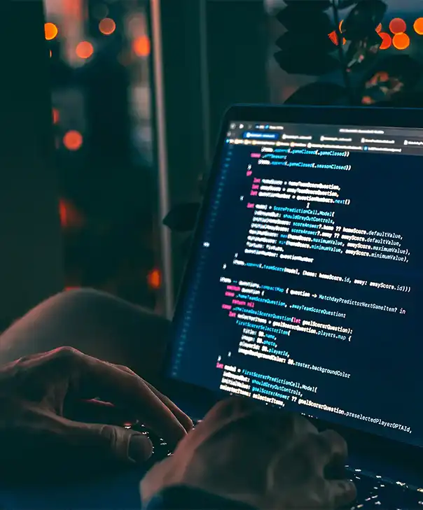 A man types code on a screen